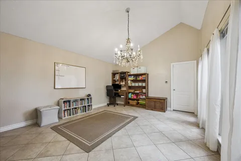 a view of a workspace with furniture and a chandelier fan