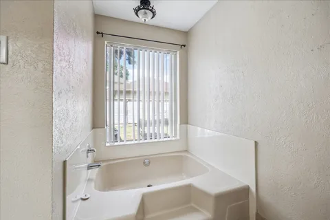 a white bath tub sitting next to a window