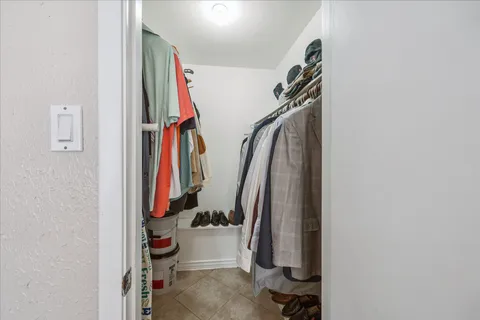 a view of walk in closet with clothes