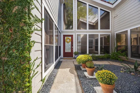 a front view of a house with outdoor seating and plants