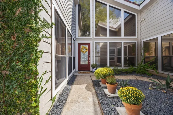 a front view of a house with outdoor seating and plants