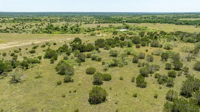 a view of a green field with an outdoor space