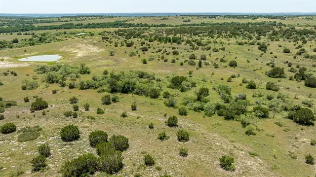 a view of a field with an ocean view