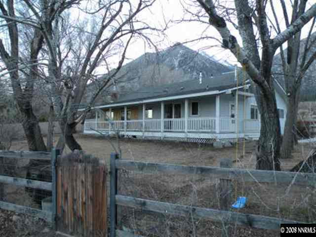 830 Foothill Road Gardnerville, NV 89460 - Photo 1 of 7 a brick house with large windows and a yard