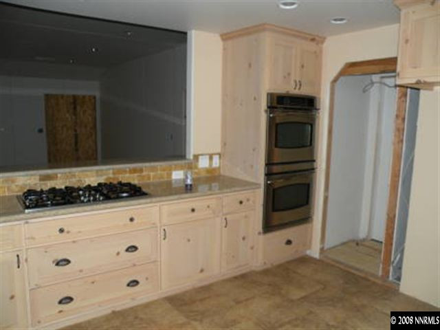 830 Foothill Road Gardnerville, NV 89460 - Photo 4 of 7 a kitchen with white cabinets and refrigerator