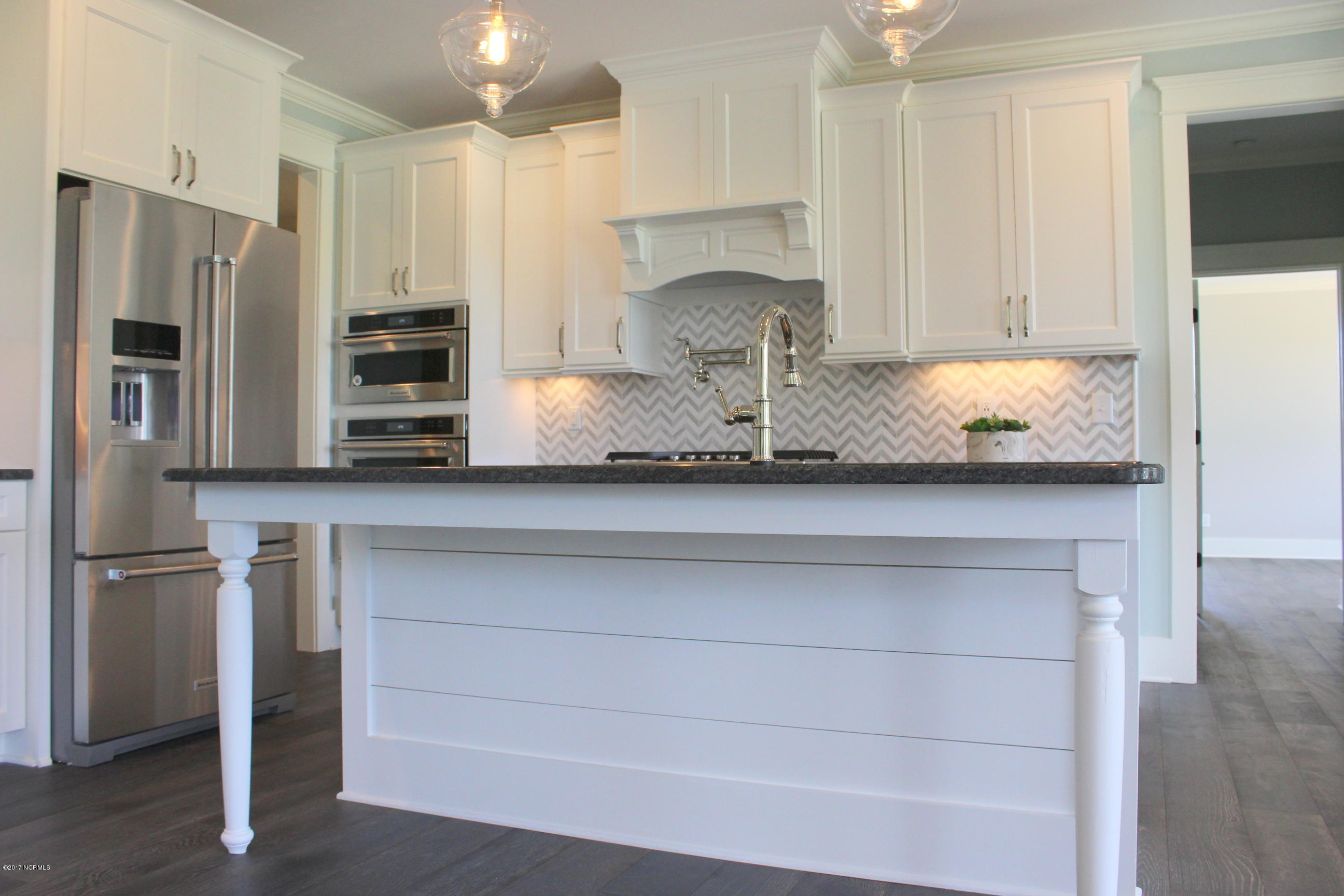 3747 Mobleys Bridge Road Grimesland, NC 27837 - Photo 25 of 86 granite island has farmhouse style legs to allow for stools to slide under