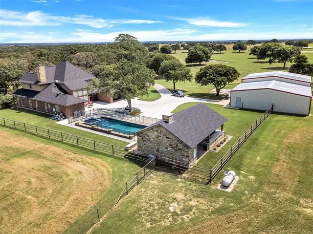 a aerial view of a house with a yard basket ball court and outdoor seating