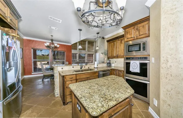 a kitchen with stainless steel appliances granite countertop a stove oven and a refrigerator