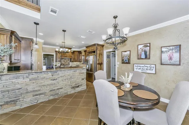a dining room with kitchen island a table and chairs