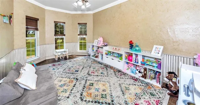 a bedroom with furniture and a book shelf