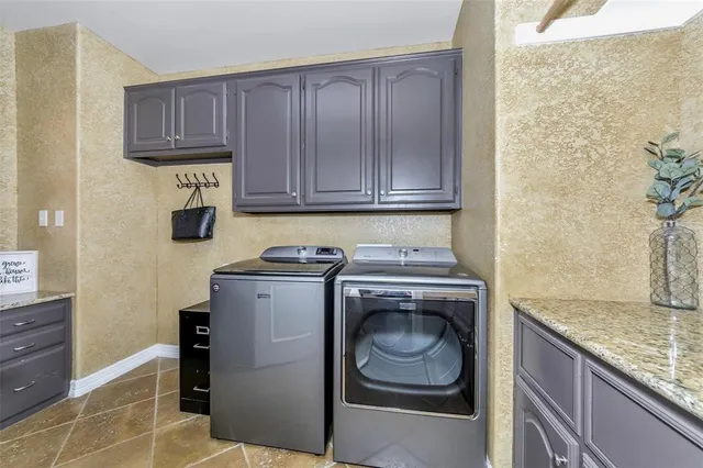 a utility room with sink dryer and washer