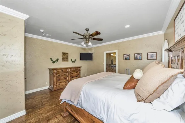 a spacious bedroom with a bed and a ceiling fan