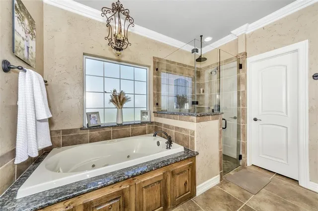 a bathroom with a granite countertop sink a mirror a bathtub and shower