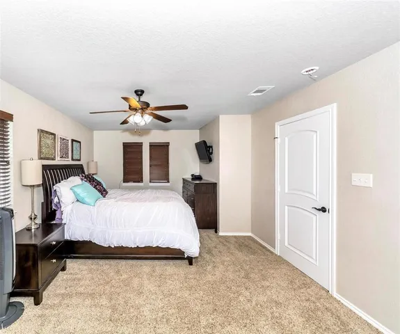 a bed room with a bed and a large window