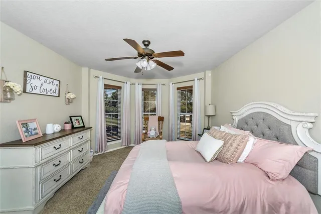 a bedroom with a large bed and a chandelier