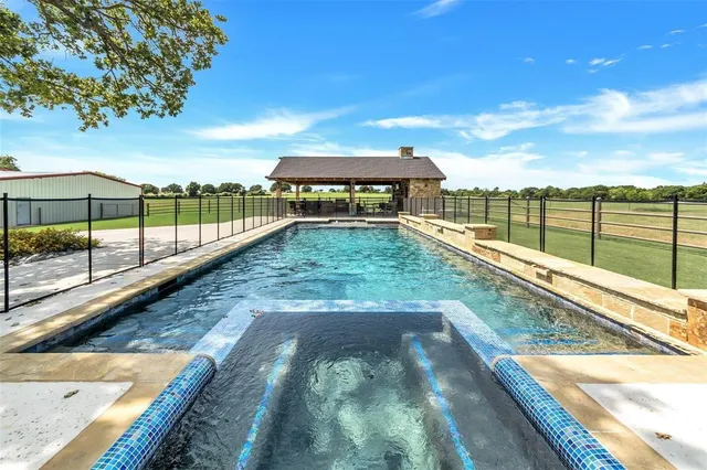 a view of a house with a yard and basketball court