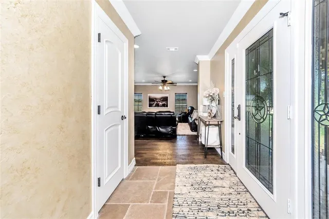a hallway with a view of living room with furniture