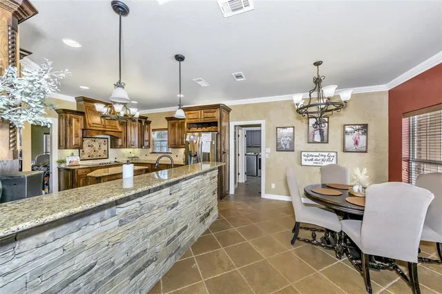 a large kitchen with a table and chairs
