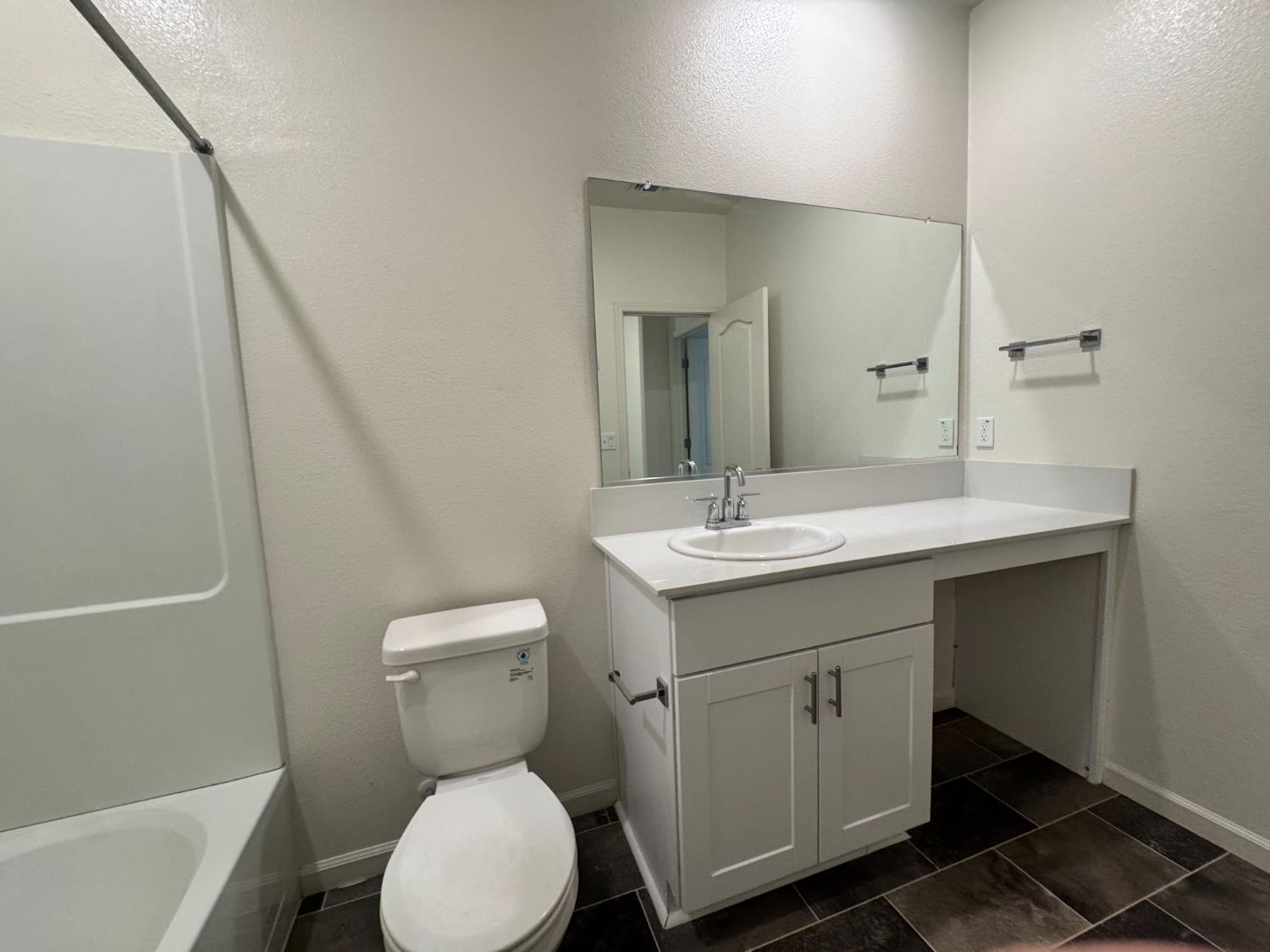 4271 Freemark Avenue Merced, CA 95348 - Photo 17 of 37 a bathroom with a toilet sink and mirror