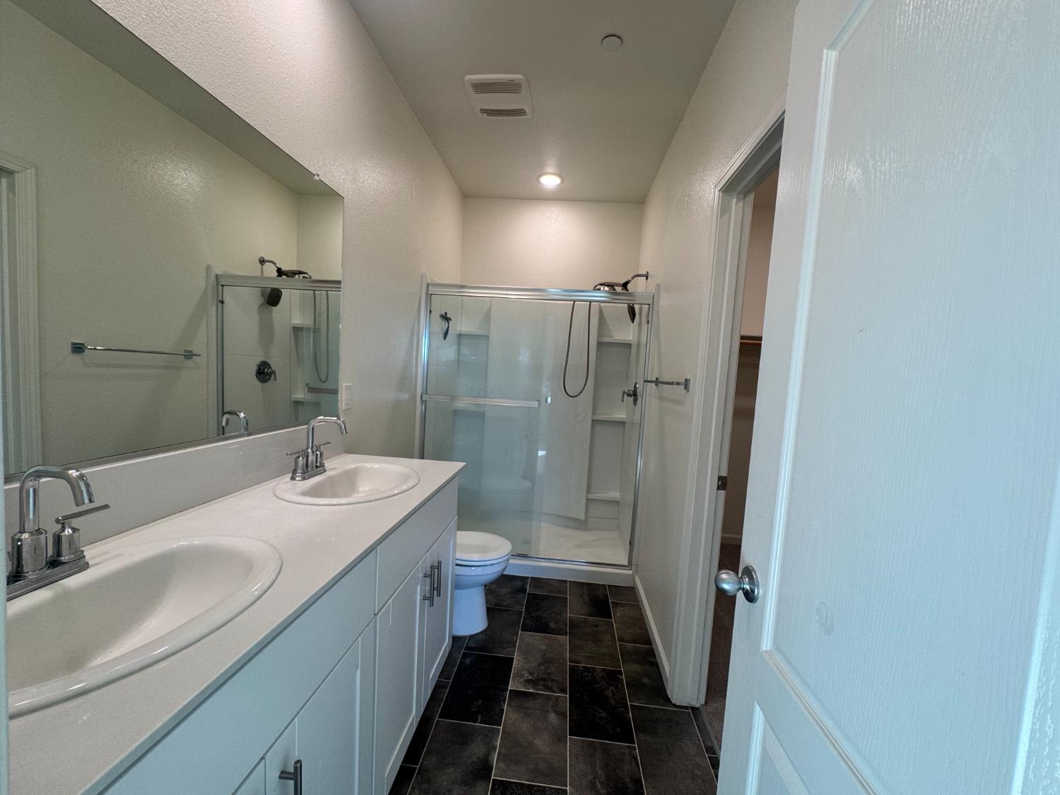 4271 Freemark Avenue Merced, CA 95348 - Photo 24 of 37 a bathroom with double vanity and a shower