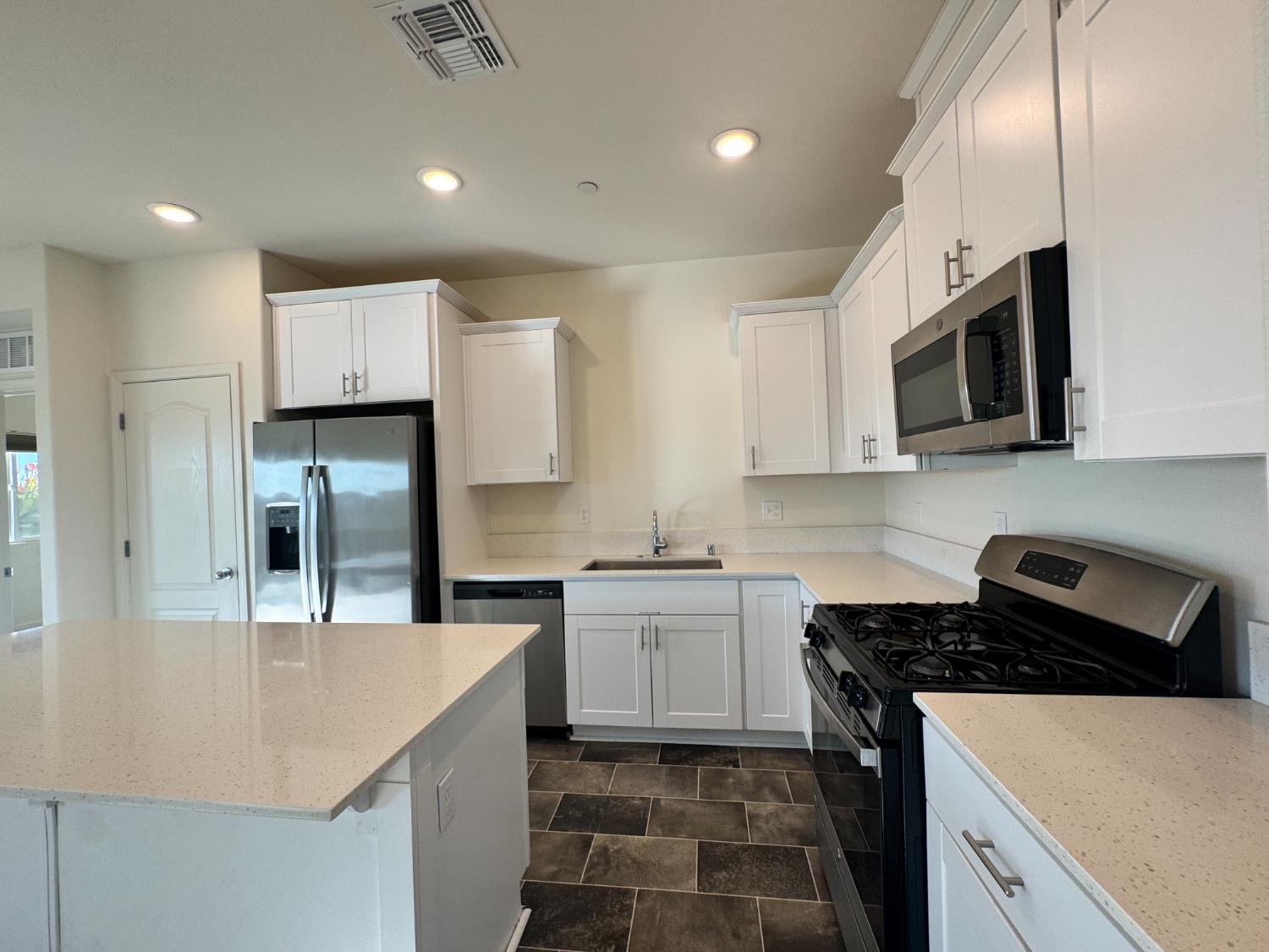 4271 Freemark Avenue Merced, CA 95348 - Photo 30 of 37 a kitchen with a sink stove and microwave