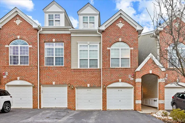 a front view of a house with a parking space