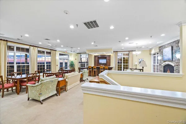 a living room with furniture and a ceiling fan