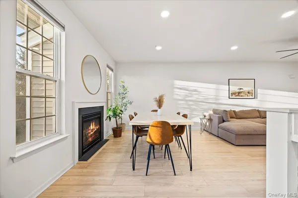 a living room with furniture a fireplace and a large window