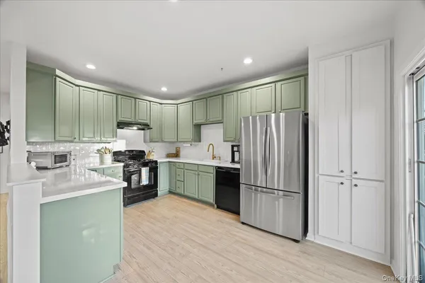 a kitchen with granite countertop a refrigerator and a sink