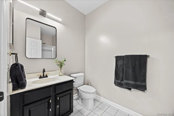 a bathroom with a toilet a sink a mirror and