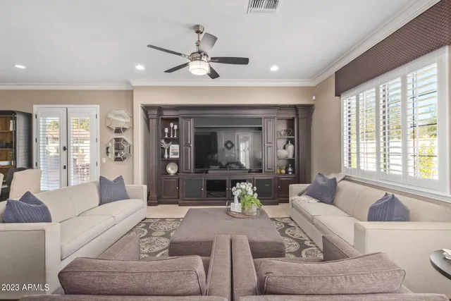 a living room with furniture and a chandelier