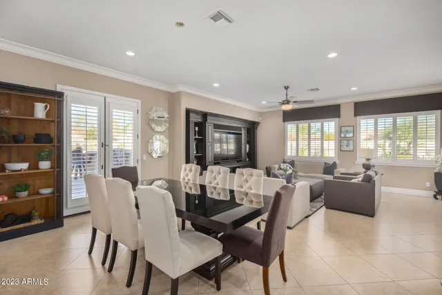 a living room with furniture a dining table and a potted plant