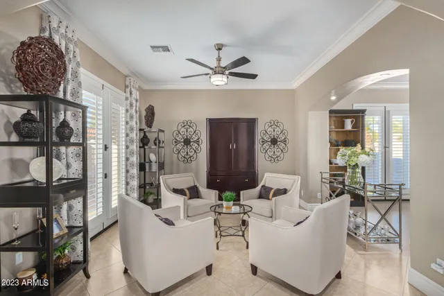 a living room with furniture and a potted plant