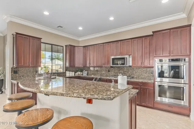 a spacious bedroom with a bed and a chandelier