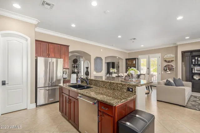 a bedroom with a large bed and a chandelier
