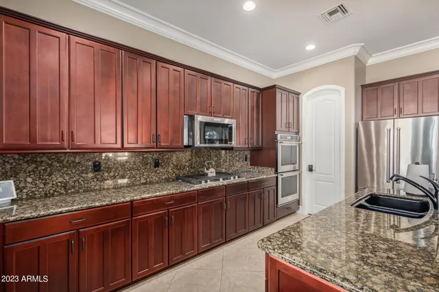 a bathroom with a granite countertop sink mirror vanity and toilet