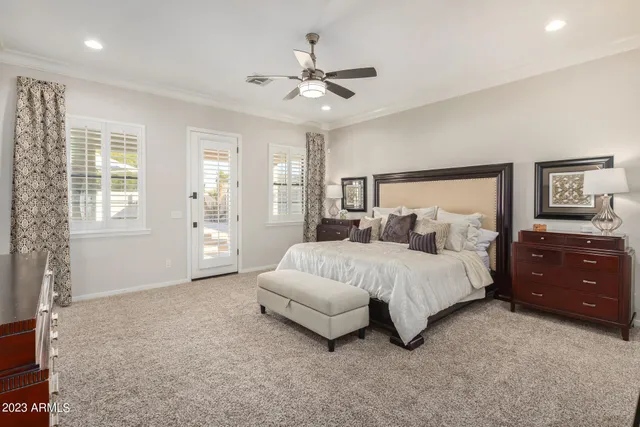 a bedroom with two beds and painting on the wall