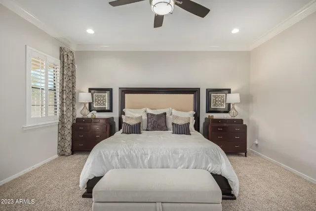 a living room with furniture a ceiling fan and a window