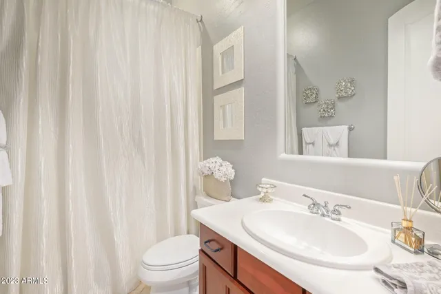 a view of a patio with chairs and table under an umbrella