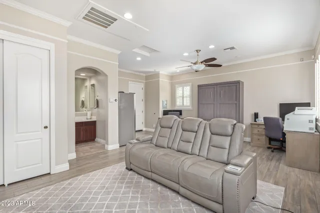 a view of a patio with couches table and chairs under an umbrella with a barbeque