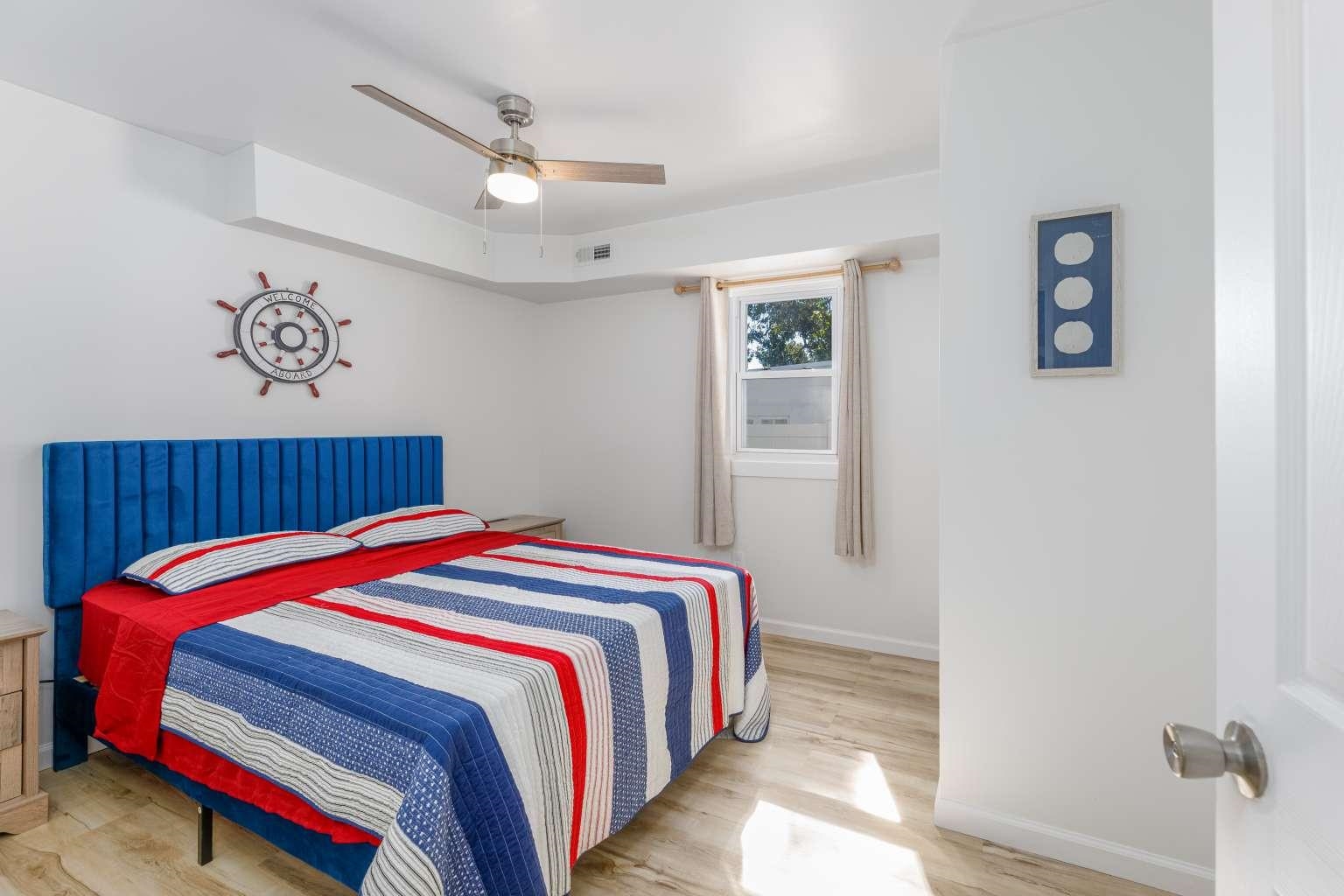5 Kenvil Road North Cape May, NJ 08204 - Photo 14 of 19 a bedroom with a bed and a chandelier