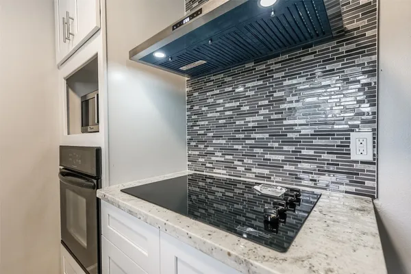 a view of kitchen island wooden cabinets and stainless steel appliances
