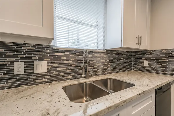 a kitchen with a sink and cabinets