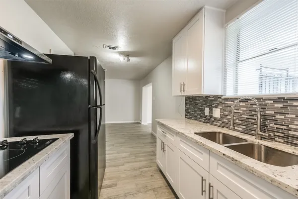 a kitchen with a refrigerator and a sink