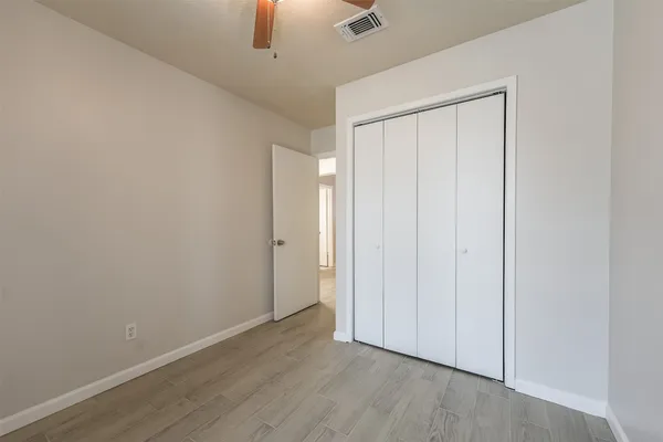 an empty room with wooden floor