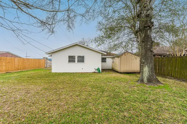 a view of a backyard with large trees