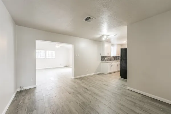 a view of a kitchen with a sink and wooden floor