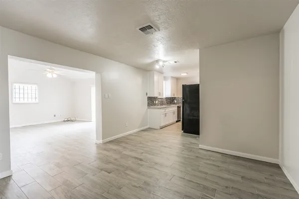 a view of a kitchen with a sink and wooden floor