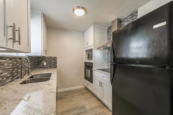 a kitchen with a refrigerator and a sink