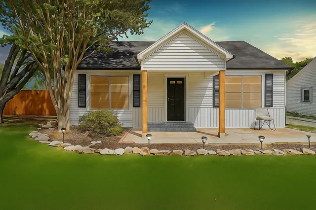 a front view of a house with garden